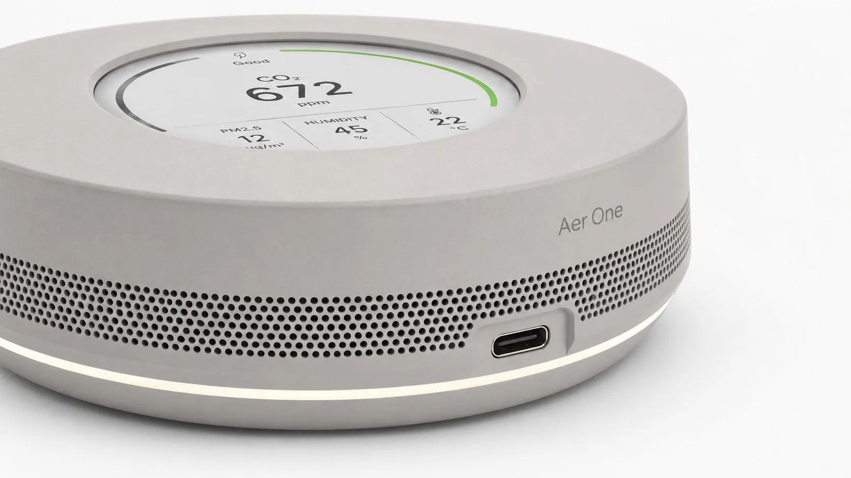 Aer One displaying current air-quality metrics on its circular display.