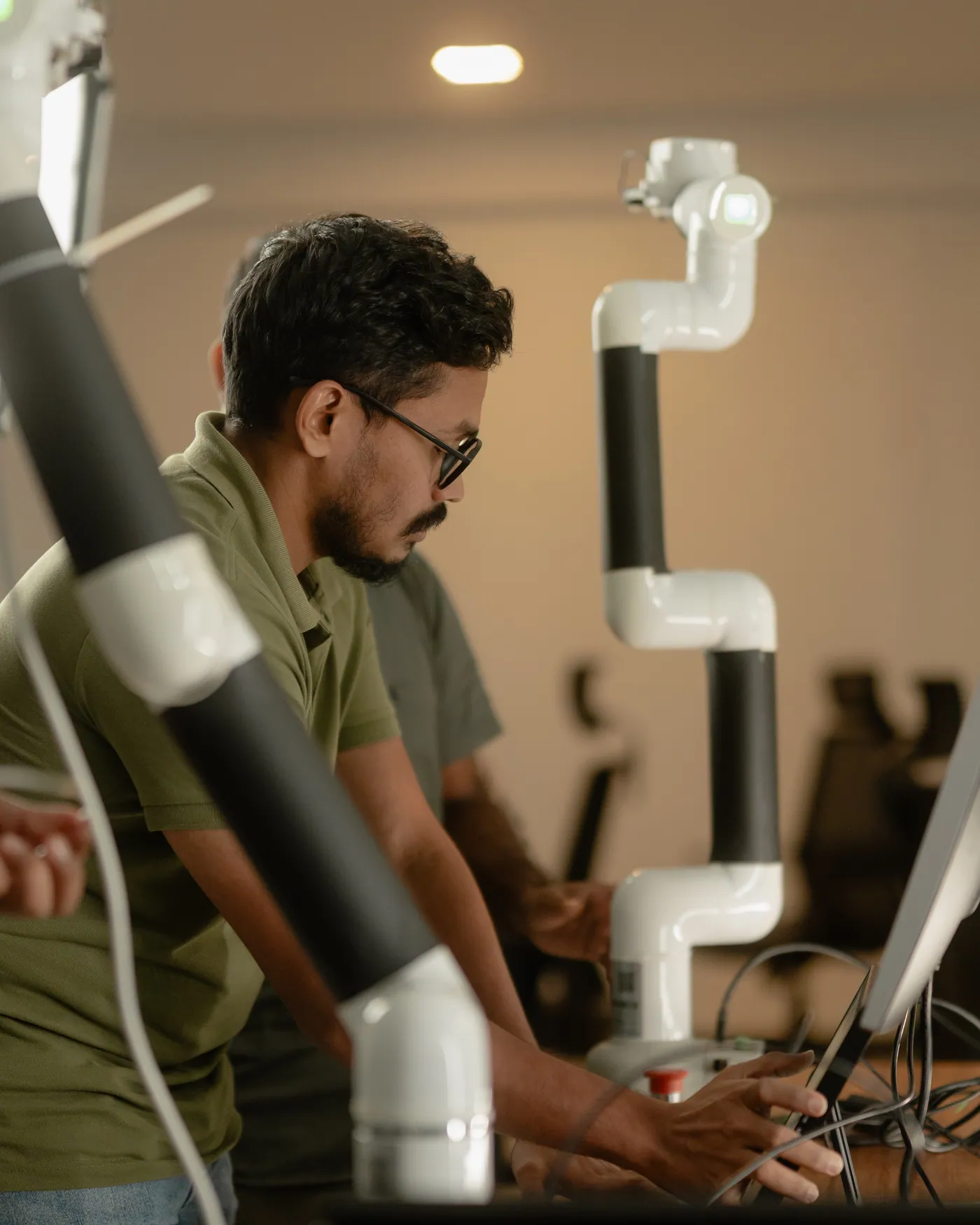 Engineers working with a collaborative robot arm